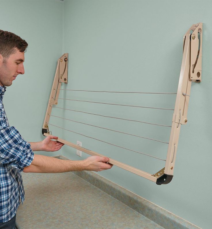 a man is working on an instrument in a room with light blue walls and tile flooring