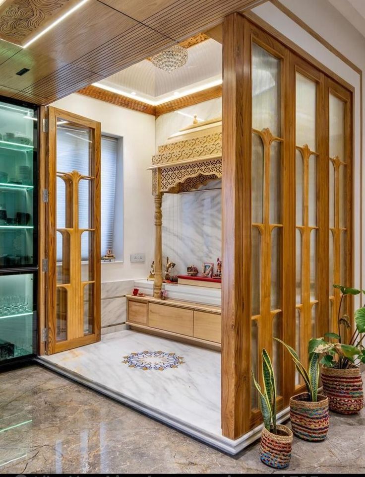 the inside of a room with wooden doors and glass shelves on either side of it