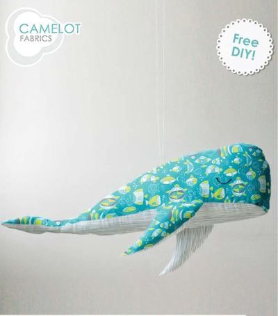 an ornament shaped like a whale hanging from a string with the caption camellot fabrics free diy