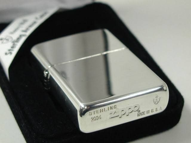 a silver lighter sitting on top of a black case