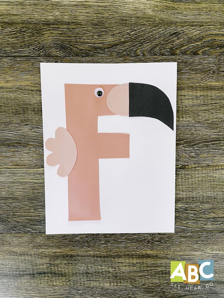 the letter f is made out of paper with a toucan on it