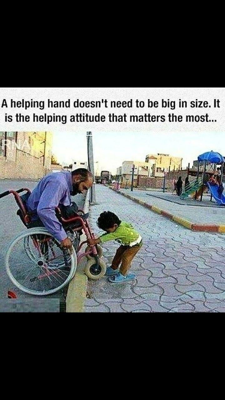 a man pushing a child in a wheel chair next to a street with other people