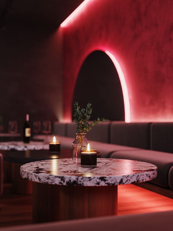 a table with candles and a vase on it in a dimly lit restaurant or bar