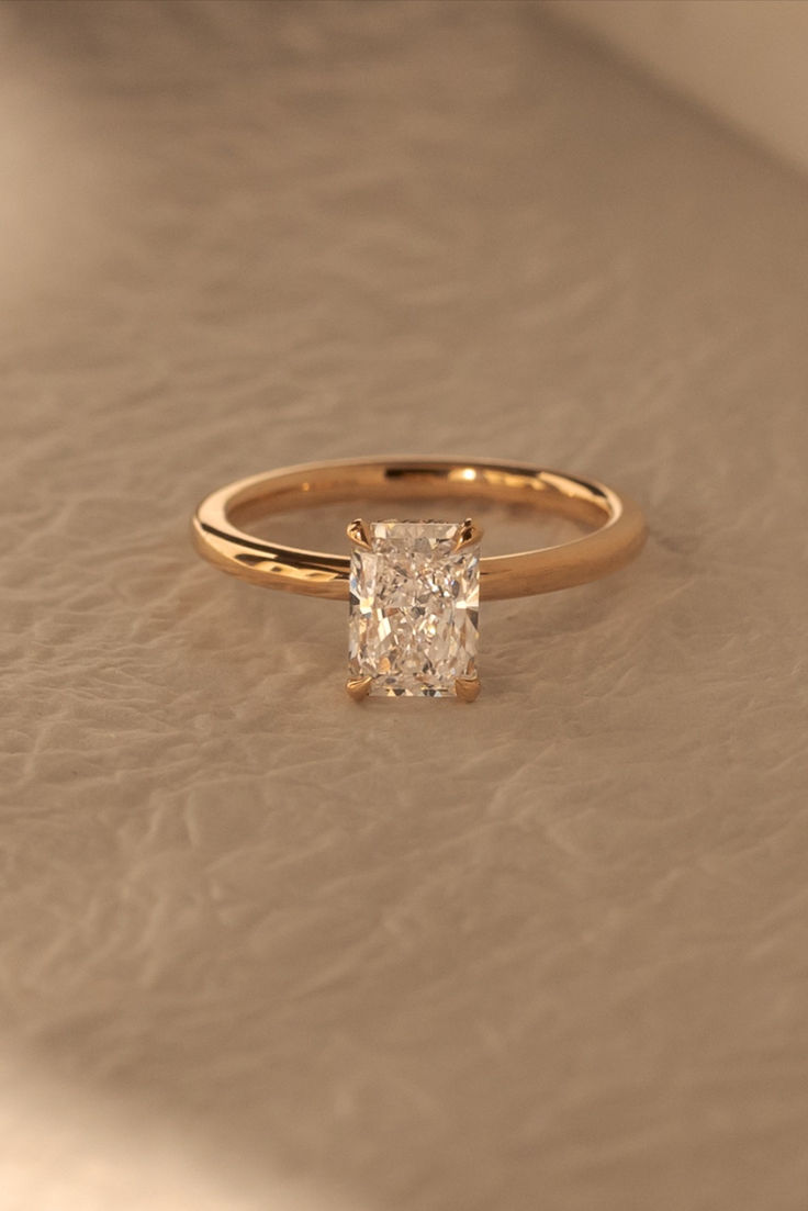 a diamond ring sitting on top of a table