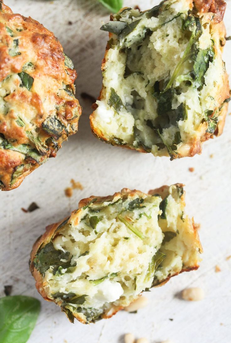 spinach and cheese muffins on a white surface