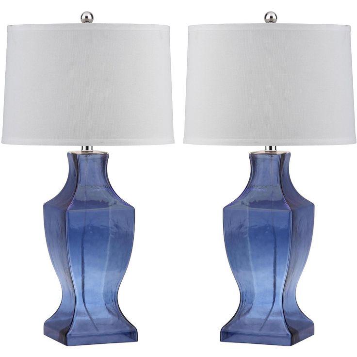 two blue vases with white lamps on them are shown in front of a white background