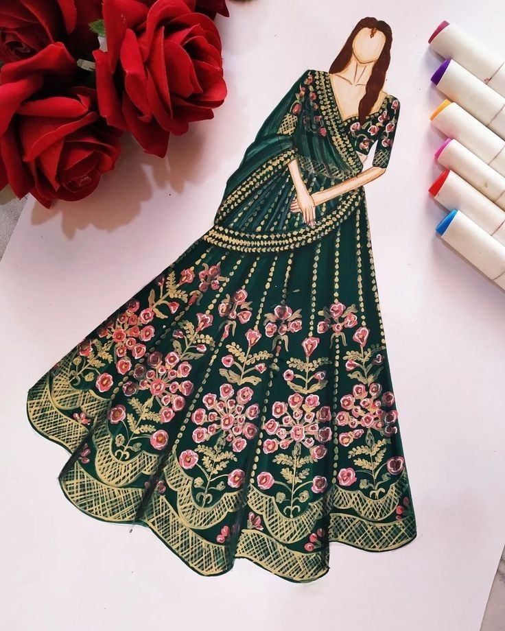 a paper cutout of a woman in a green dress next to some red roses