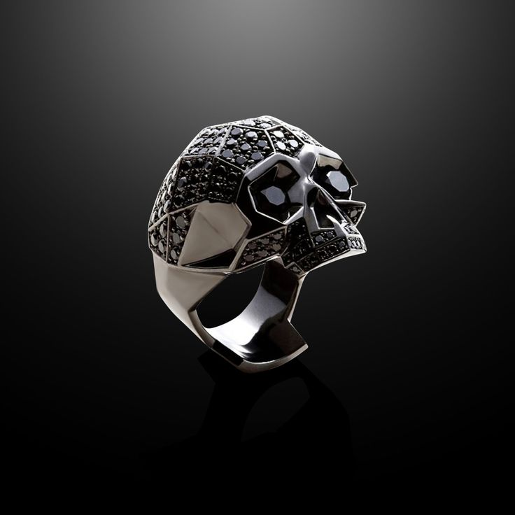 Sparkling Black CZ Diamonds lend subtle brilliance to this captivating ring in stainless steel coated with rhodium for long lasting shine. Each stone is meticulously matched for color and set by hand in this show stopper of a ring. Skull is a transient symbol signifying freedom mindset and transition into power with inner strength. 316L Stainless Steel with Rhodium Plating Pavé Black CZ Diamonds Ring, 34mm Wide Classic Titanium Jewelry For Formal Occasions, Classic Formal Titanium Jewelry, Luxury Skull Ring With Polished Finish As Gift, Luxury Polished Skull Ring As Gift, Silver Titanium Promise Ring, Silver Skull Ring With Polished Finish For Formal Occasions, Formal Silver Skull Ring With Polished Finish, Luxury Skull Ring With Polished Finish For Gift, Formal White Gold Skull Ring In Sterling Silver