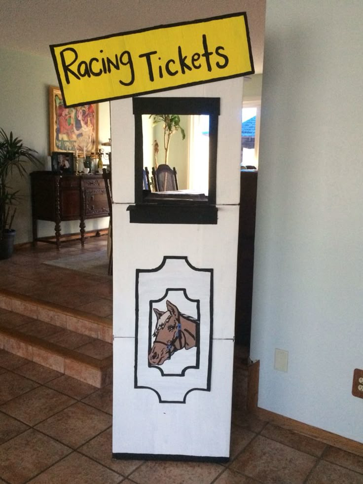 a horse ticket booth sitting on top of a tile floor next to a stair case