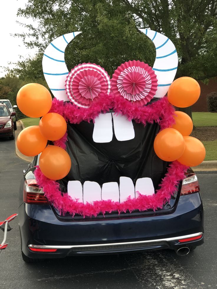 a car decorated with balloons and decorations in the shape of a monster's head