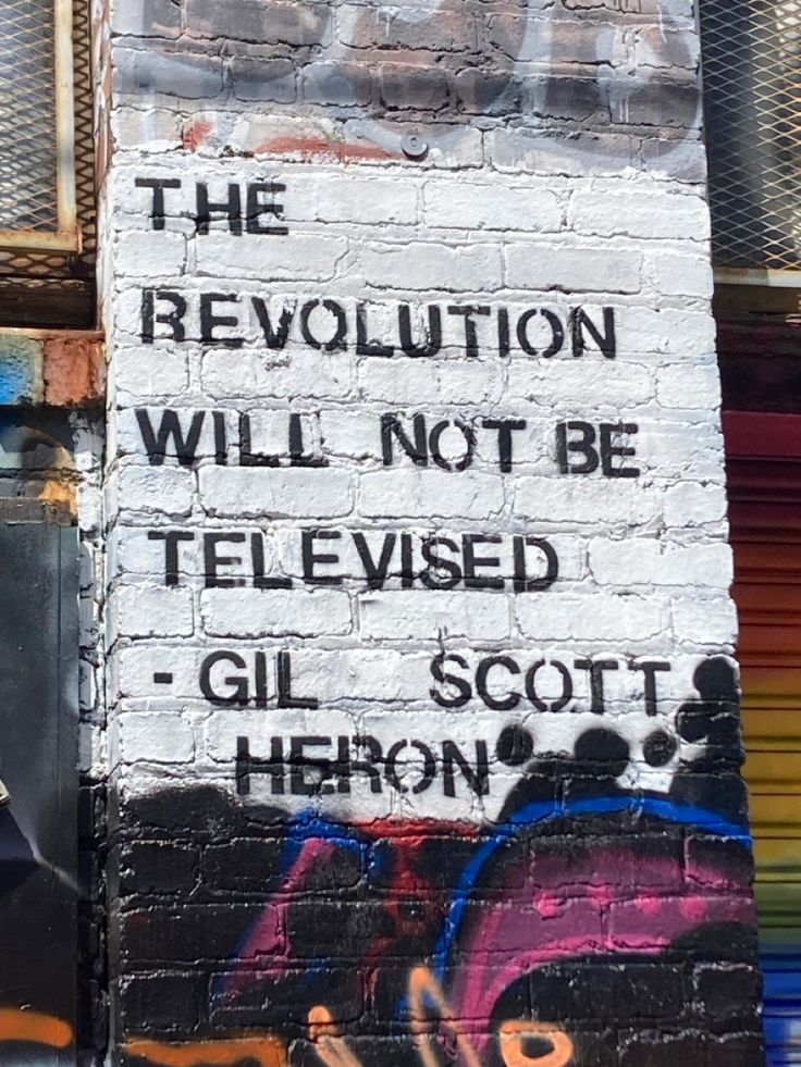 graffiti on the side of a building that says, the revolution will not be televised gil scott heron