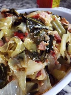 a white bowl filled with pasta and vegetables