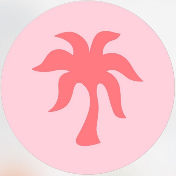 a pink circle with a palm tree in the center on a white background and blurry light behind it