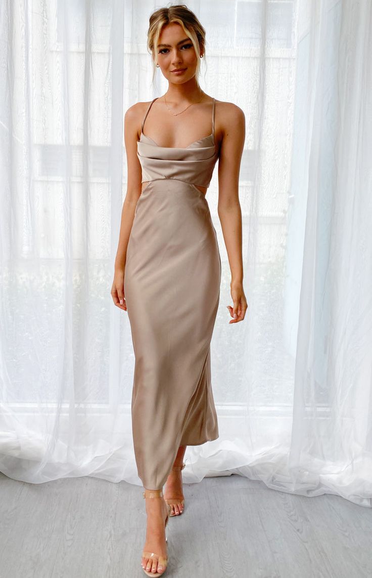 Mocha Cut Out Maxi Dress

How to style:
This stunning satin cut-out maxi dress is perfect for your next event, whether you're going to a wedding, 21st birthday or long lunch!


 
Features:
  
 * Thin adjustable shoulder straps 
 * Cowl neckline 
 * Padded bust 
 * Cut out at the waist 
 * Open back 
 * Invisible zip at the back 
 * Maxi length 
 * Unlined 
 * Thin satin-like material with minimal stretch  
This is the perfect formal dress for your next event! Cut Out Maxi Dress, Wedding Guest Attire, Tan Dress, Cutout Maxi Dress, Grey Maxi Dress, Guest Attire, Wedding Attire Guest, Beige Dresses, Dress Satin