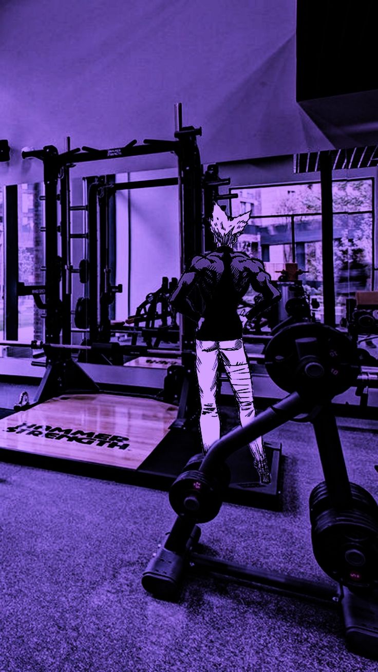 a man is doing squats on a bench in a crossfit gym with purple lighting