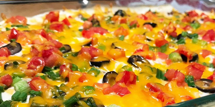 a casserole dish with vegetables and cheese on it