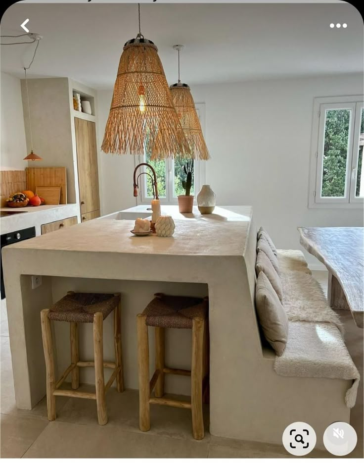 a kitchen island with two stools next to it