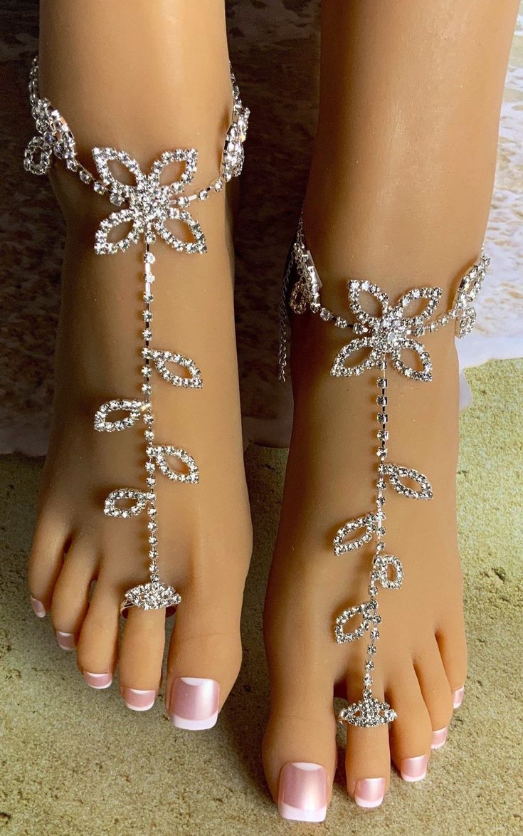 This pair of elegant barefoot sandals feature rhinestones of a flower and petals with a single chain that adorn the ankle and top of the foot. A size adjusting diamond shaped toe ring holds the piece in place on the foot. Each piece detaches at the back of the ankle with a lobster claw latch. They are size adjustable and one size fits most. Comfortable and versatile, they will lend themselves to casual or formal events. My barefoot sandals are sold as a pair and are one size fits most. All items are made in a smoke free environment. *If there is any issue with your footwear, please let me know so that I can correct it. Thanks for visiting my shop!👣 Manga Jewelry, Crystal Barefoot Sandals, Barefoot Sandals Beach Wedding, Head Chain Jewelry, Barefoot Sandals Wedding, Columbia Tn, Diamond Anklet, Beach Wedding Sandals, Foot Bracelet