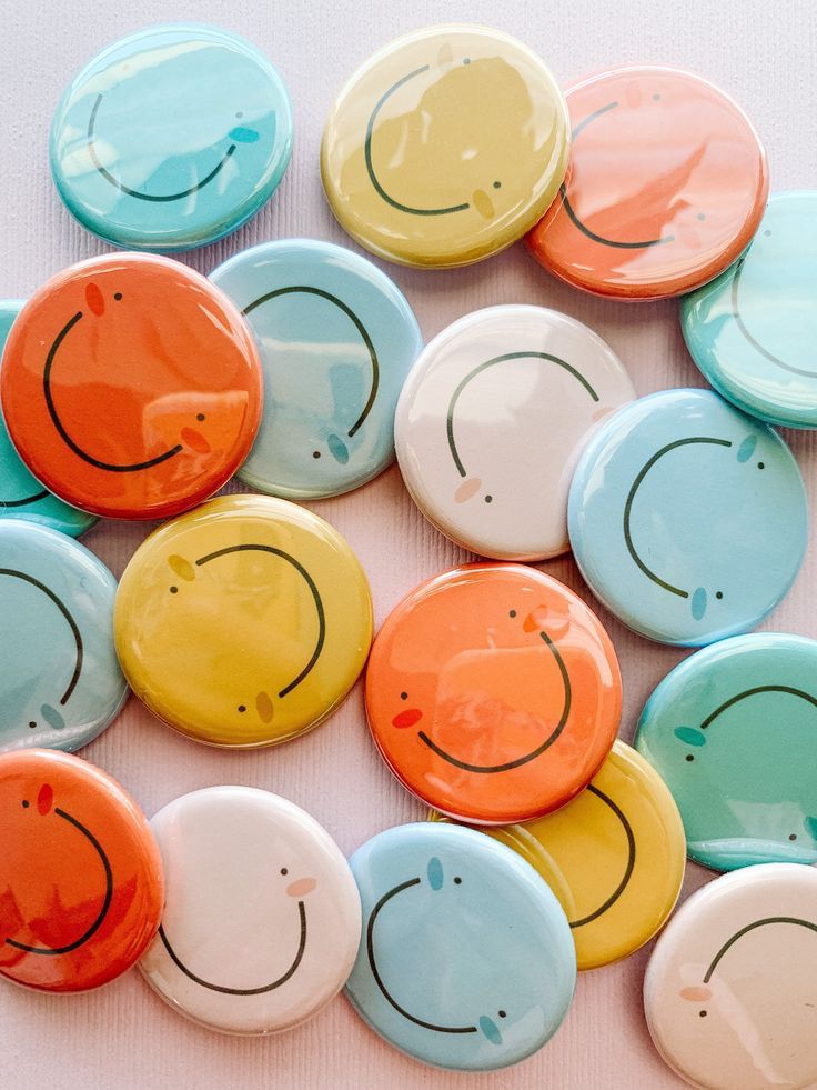 many different colored buttons with smiley faces on them