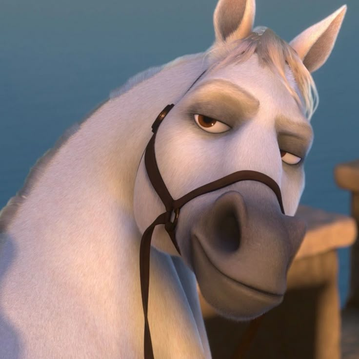 a white horse wearing a bridle next to a wooden bench and water in the background