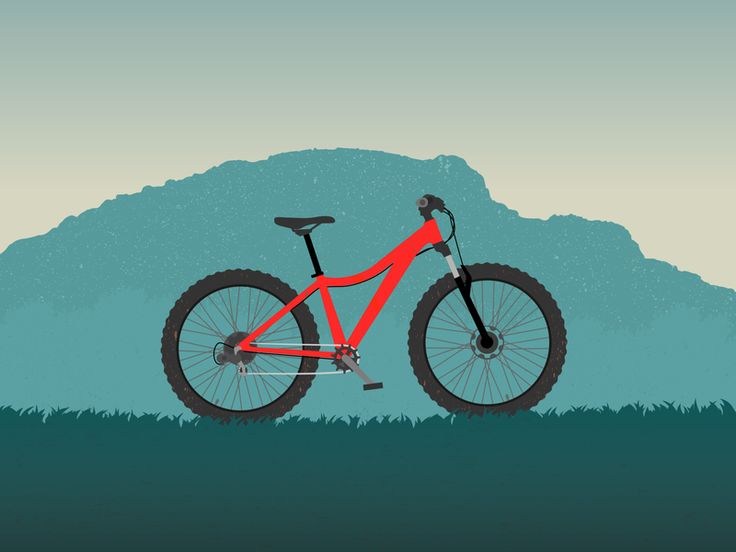 a red mountain bike parked in the grass