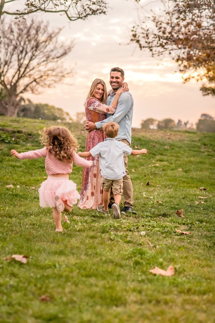 the family is playing in the grass together