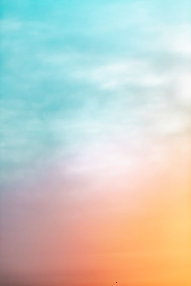 an airplane is flying in the sky at sunset