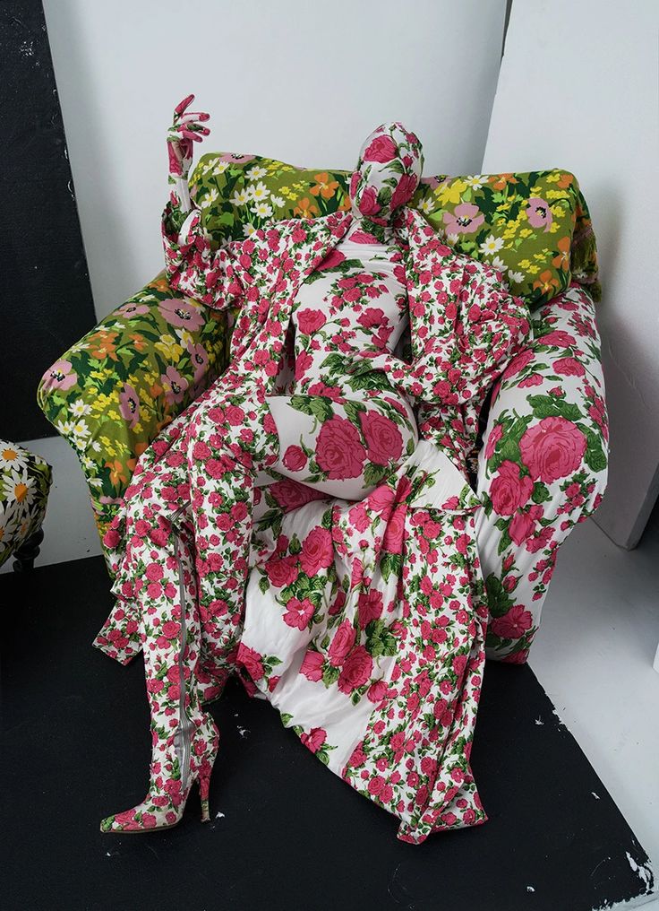 a chair covered in pink and green floral fabric