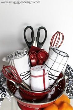 a bowl filled with oranges and kitchen utensils