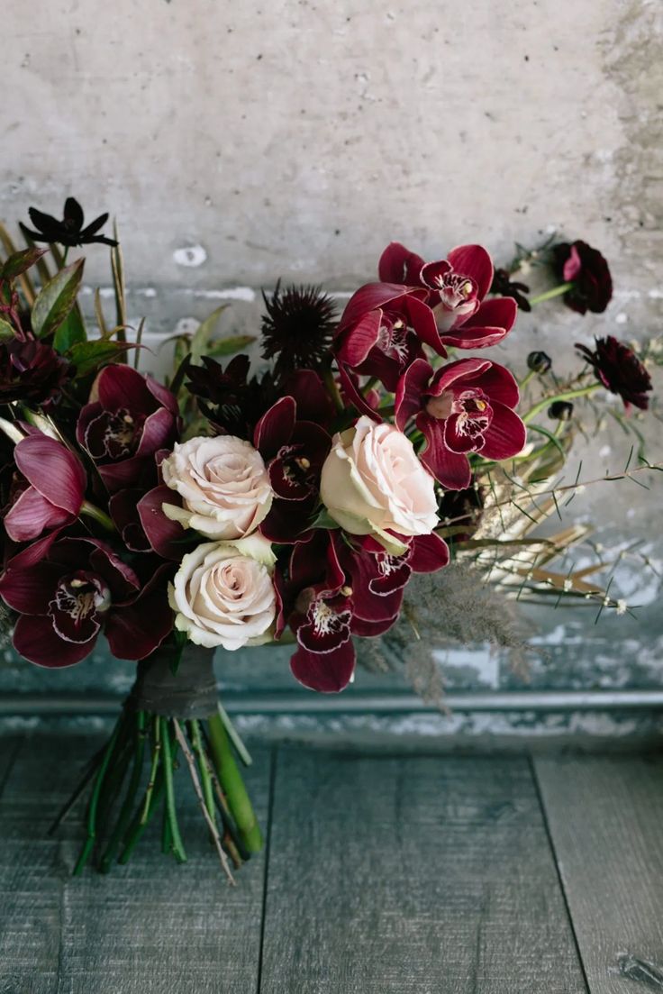 a bouquet of flowers sitting on top of a wooden table