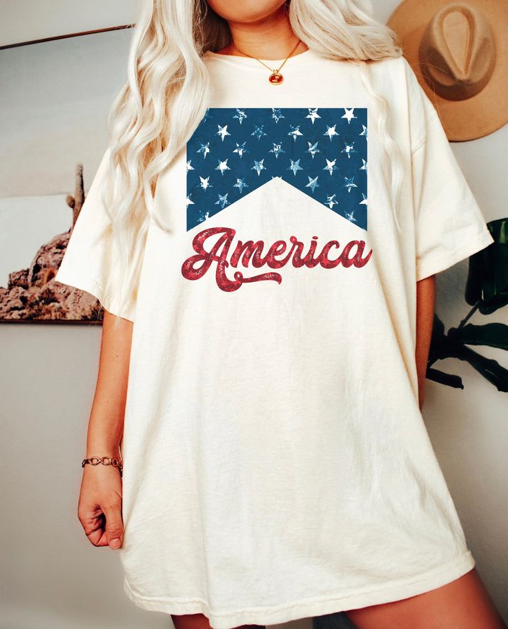 America Shirt. Printed on Comfort Colors Tee. Must size up for oversized look. See size chart for measurements. Comfort Colors® 1717 Medium fabric (6.1 oz/yd² (206.8 g/m²)) Relaxed fit Sewn-in twill label 100% ring-spun cotton Gildan is back with its garment-dyed t-shirt, a fully customizable tee made 100% with ring-spun cotton. Care instructions Machine wash: cold (max 30C or 90F); Do not bleach; Tumble dry: low heat; Iron, steam or dry: low heat; Do not dry clean. ★SHIPPING TIMES All of our de Summer Cotton Shirt With Logo Print, Relaxed Fit Crew Neck Shirt Made In Usa, Casual White Tops Made In Usa, White Short Sleeve Tops Made In Usa, 4th Of July Cotton T-shirt With Text Print, Short Sleeve Tops, Relaxed Fit, Made In Usa, 4th Of July Cotton Tops With Screen Print, Summer Crew Neck Tops Made In Usa, Cotton Letter Print Shirt For 4th Of July