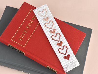 a bookmark with hearts on it sitting on top of a binder