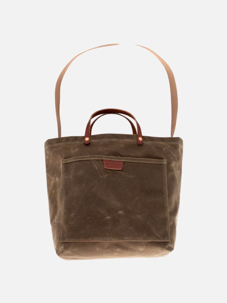 This is the perfect carry-all, market tote for every day use. It has leather handles for carrying by your side and also a hide-away strap for throwing it on your shoulder. Body Dimensions 15" x 12.5" x 7" Pocket Dimensions 12.5" x 10" 18 oz waxed duck canvas 9 oz USA harness leather Cotton webbing shoulder strap Made in USA Large Satchel With Leather Handles For Shopping, Canvas Bucket Satchel With Top Carry Handle, Everyday Coated Canvas Satchel With Handles, Brown Canvas Bucket Bag For On-the-go, Everyday Use Canvas Bag With Double Rolled Handles, Everyday Canvas Bag With Double Rolled Handles, Medium Travel Satchel, Medium Shoulder Bag With Leather Handles For Shopping, Brown Coated Canvas Bucket Bag For Everyday Use