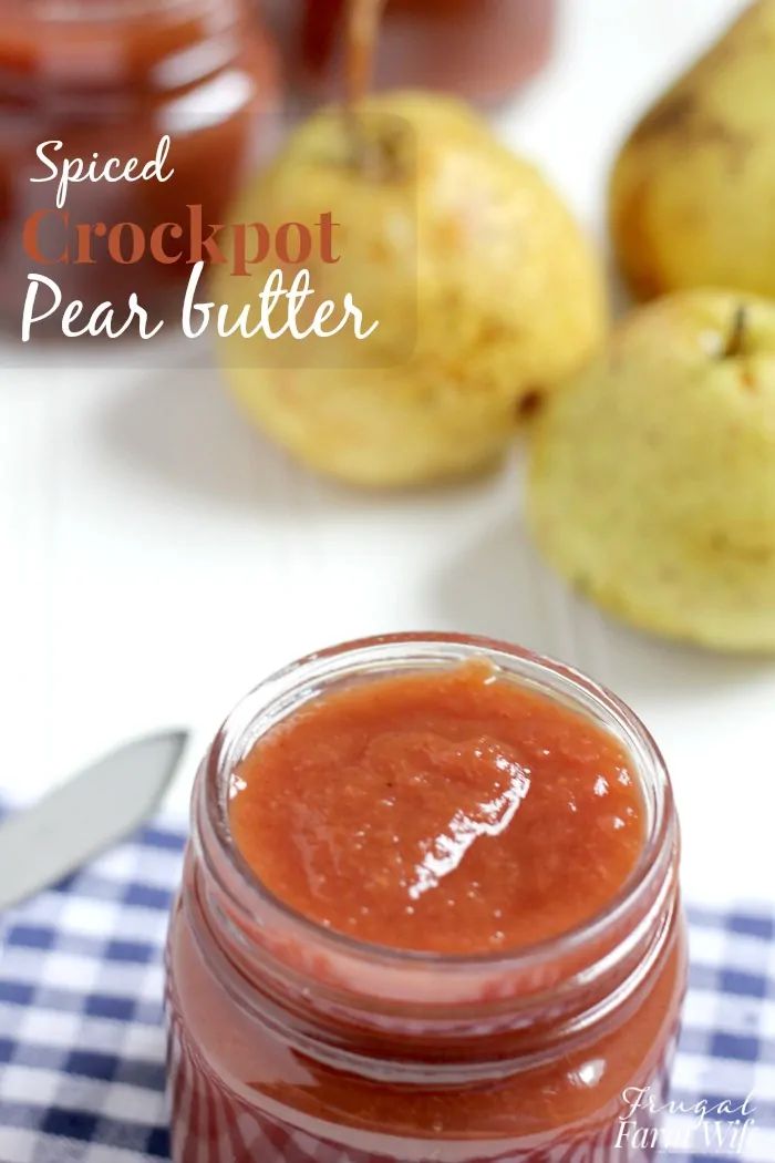 a jar filled with peach butter sitting on top of a blue and white checkered table cloth