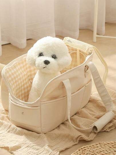 a small white teddy bear sitting in a bag