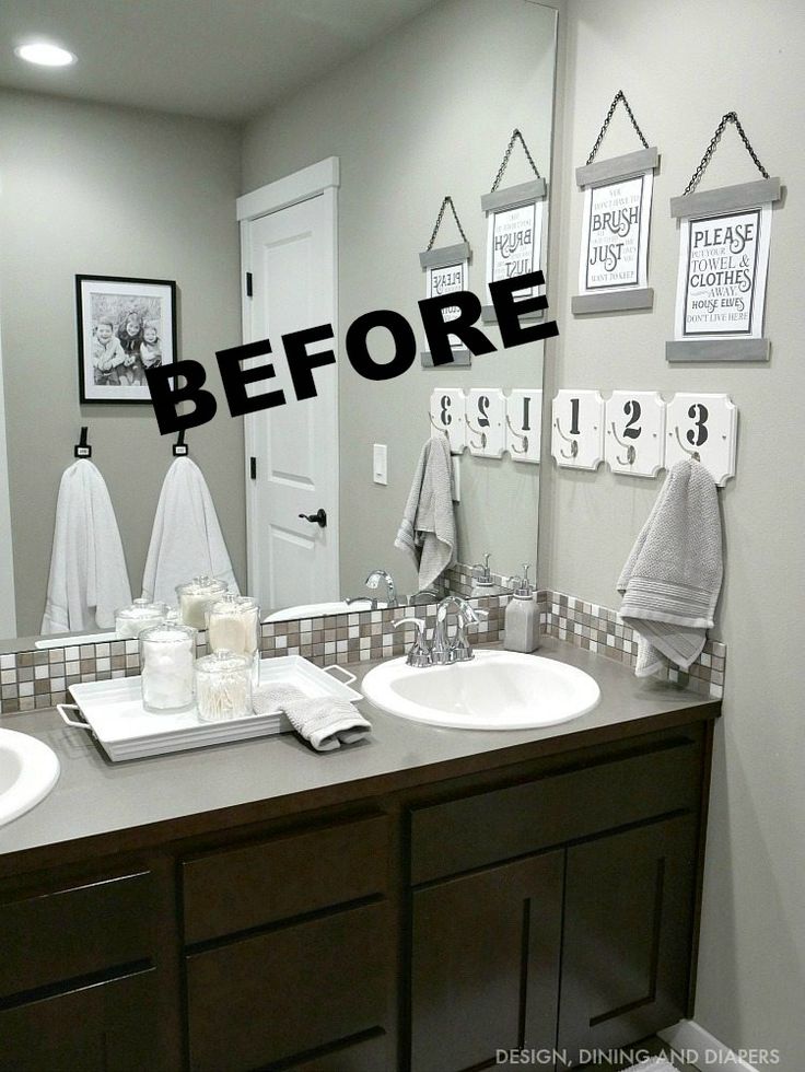 a bathroom with two sinks, mirrors and pictures on the wall