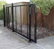 a black gate that is next to a fence