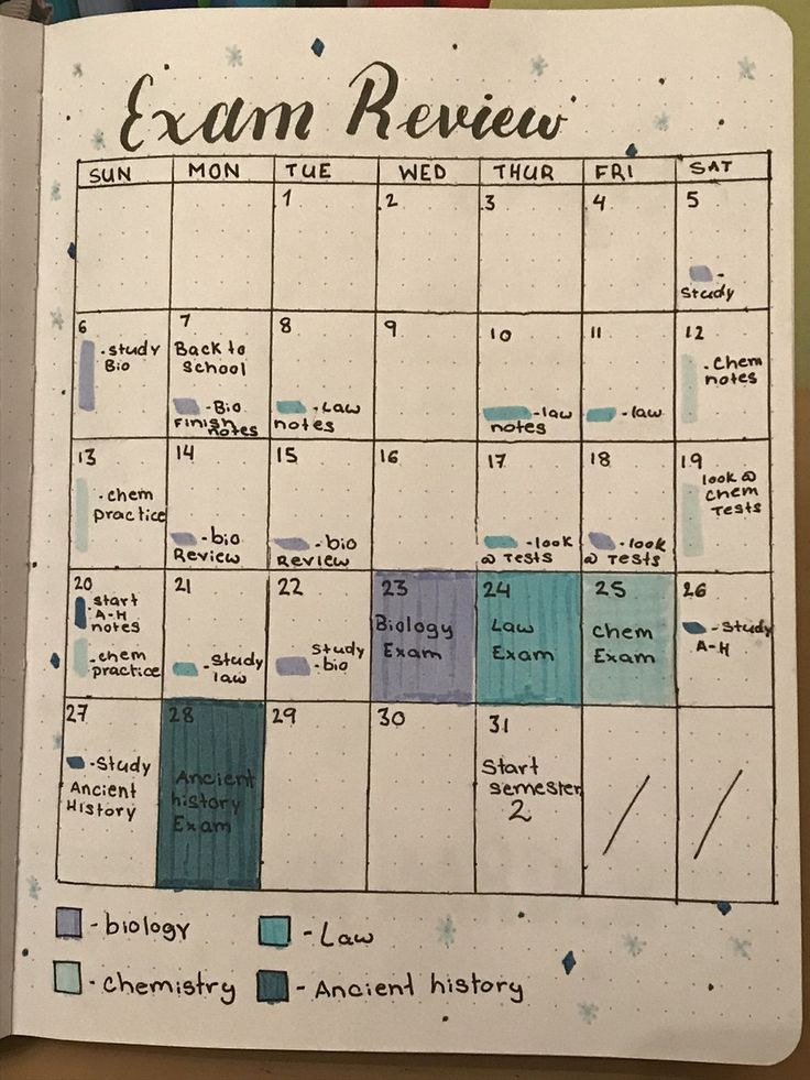 an open planner with blue and green squares on it