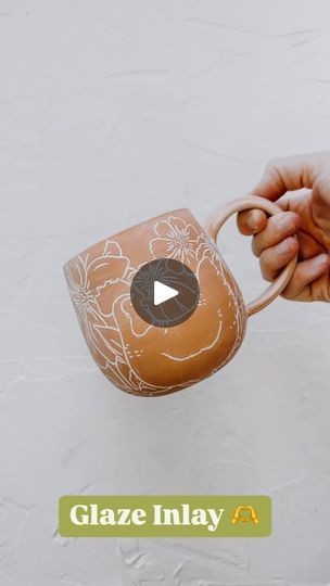 a person is holding a clay pot with flowers on it and the words glaze inlay below