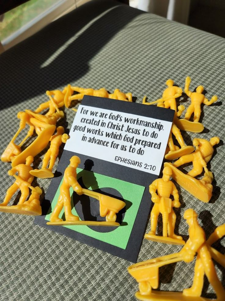 some yellow plastic figures with a sign on them that says it's very hard to tell what they are