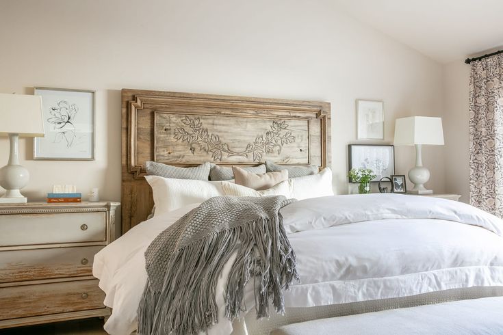 a bed with white linens and pillows in a bedroom