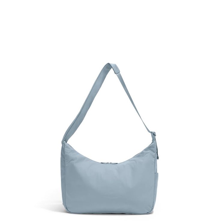 Weighing in at just under a pound, this large crossbody bag’s softly structured shape drapes well when worn, and has just enough support to keep its contents securely contained. It’s organized, versatile, and easily packs down when needed, making it a perfect crossbody bag for getting there—and then getting around. Everyday Light Blue Bag With Adjustable Strap, Light Blue Everyday Bag With Adjustable Strap, Versatile Travel Bag With Soft Interior, Versatile Light Blue Bag For Everyday Use, Everyday Light Blue Crossbody Shoulder Bag, Light Blue Crossbody Shoulder Bag For Everyday, Light Blue Shoulder Bag For Travel, Light Blue Crossbody Shoulder Bag For On-the-go, Everyday Light Blue Shoulder Bag With Zipper