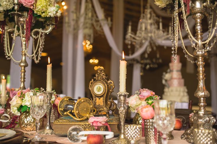 the table is set with candles, flowers and other items for an elegant wedding reception