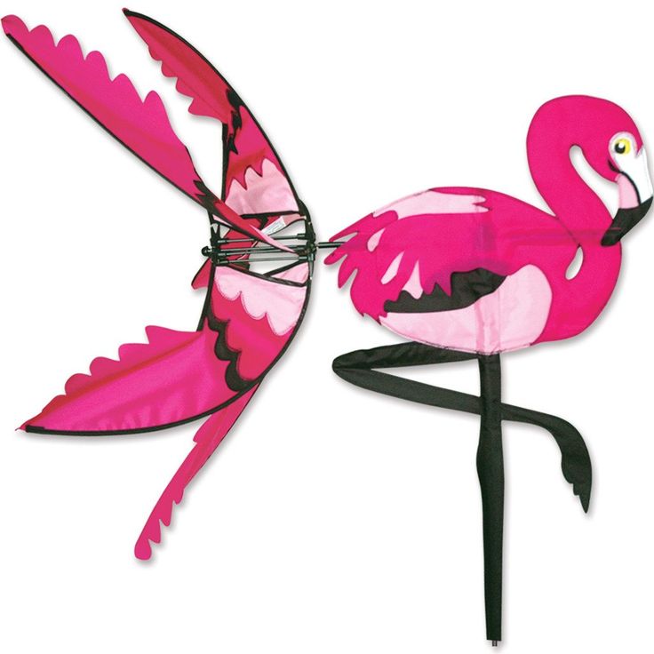 a pink flamingo standing on top of a metal pole with its wings spread out