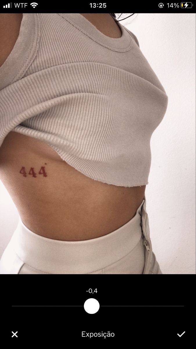 a woman's stomach with the word aa tattooed on her lower back and side