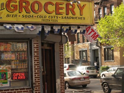 a grocery store with cars parked on the street