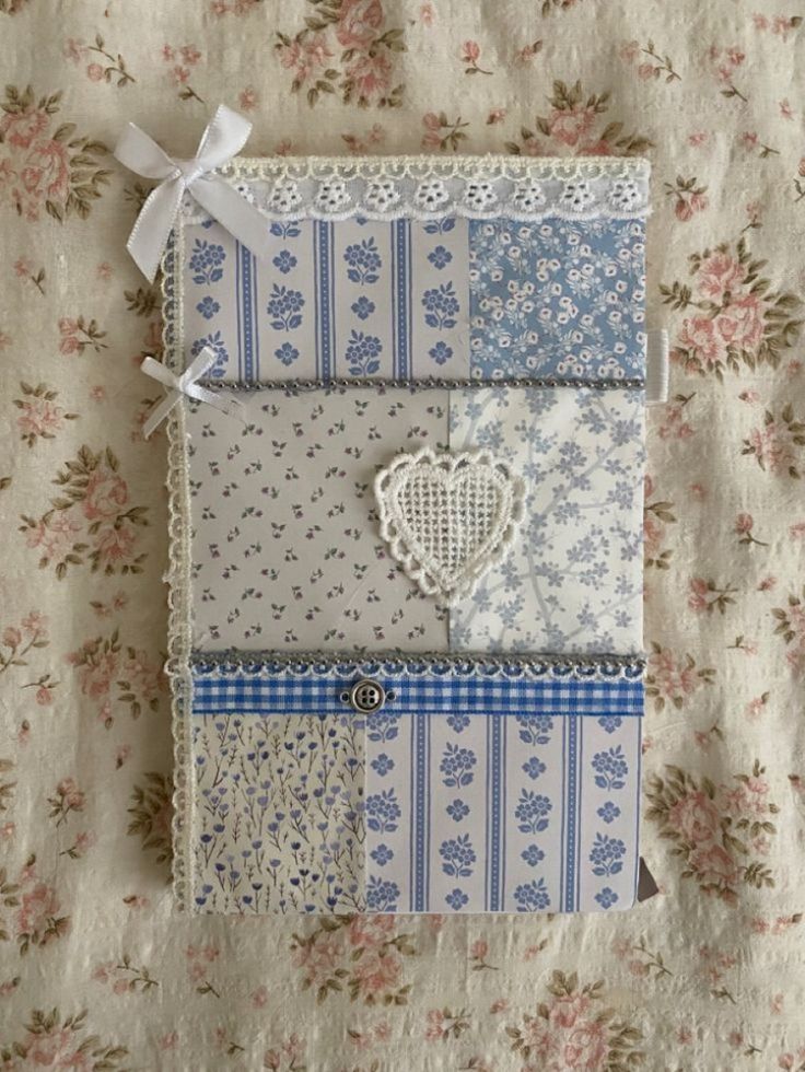 a piece of fabric with different patterns and designs on it, sitting on top of a flowered table cloth