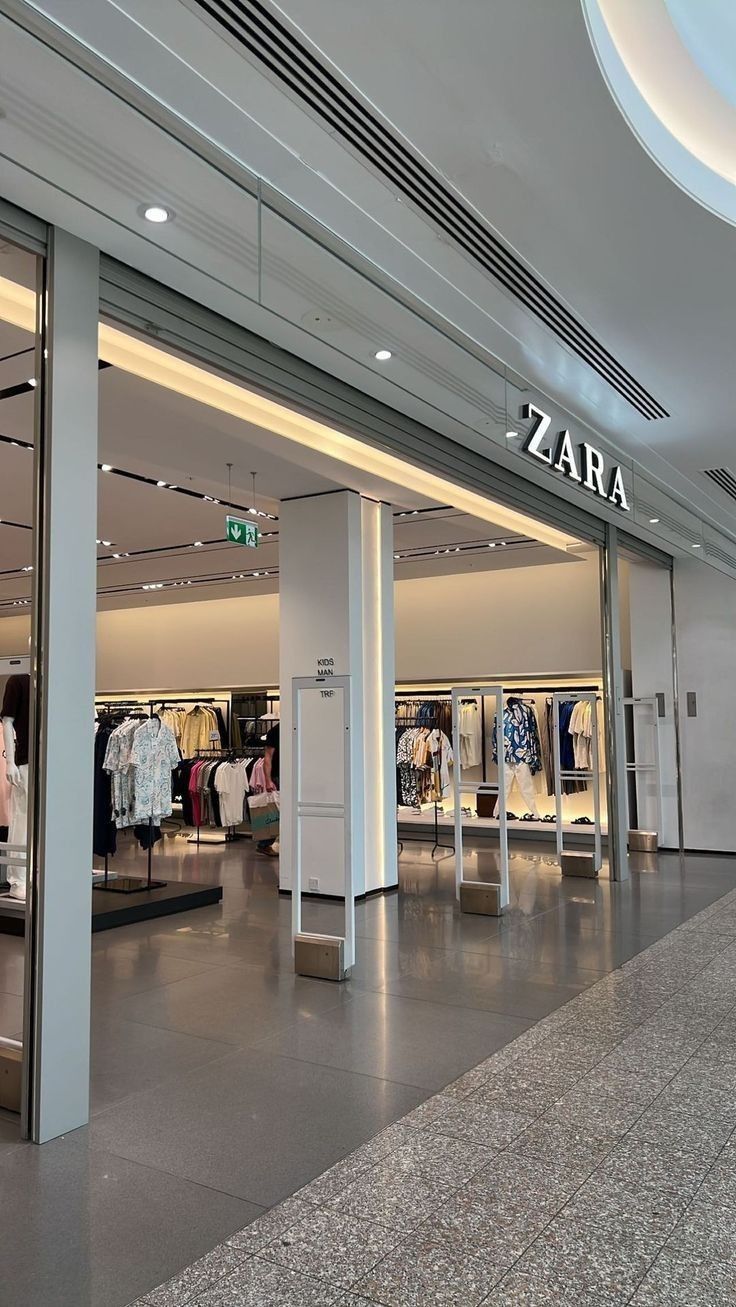 an empty shopping mall with clothes on display