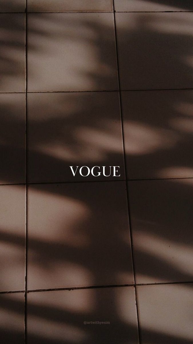 the word voque is written in white on a tile floor next to a tree