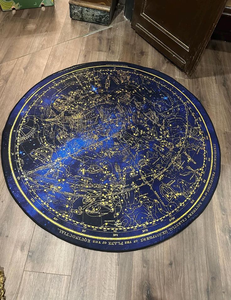 a blue and gold area rug with stars on the night sky, in a living room